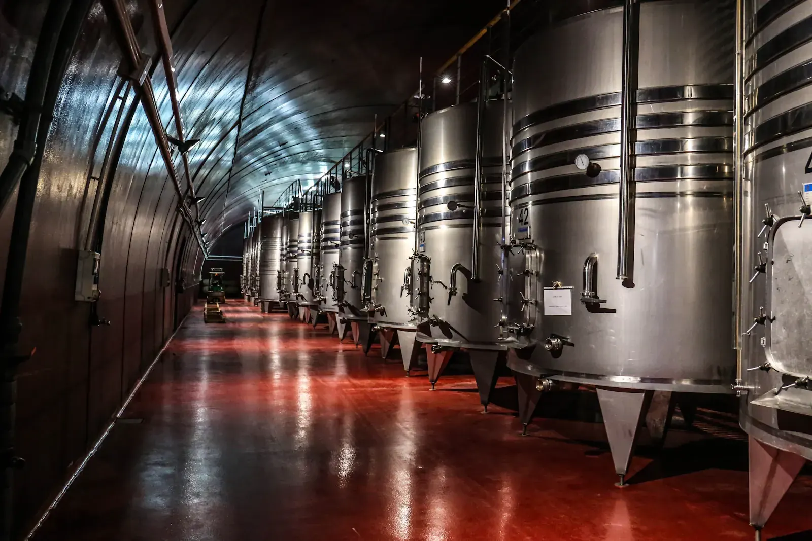 Stainless steel fermentation tanks in a winery cellar
