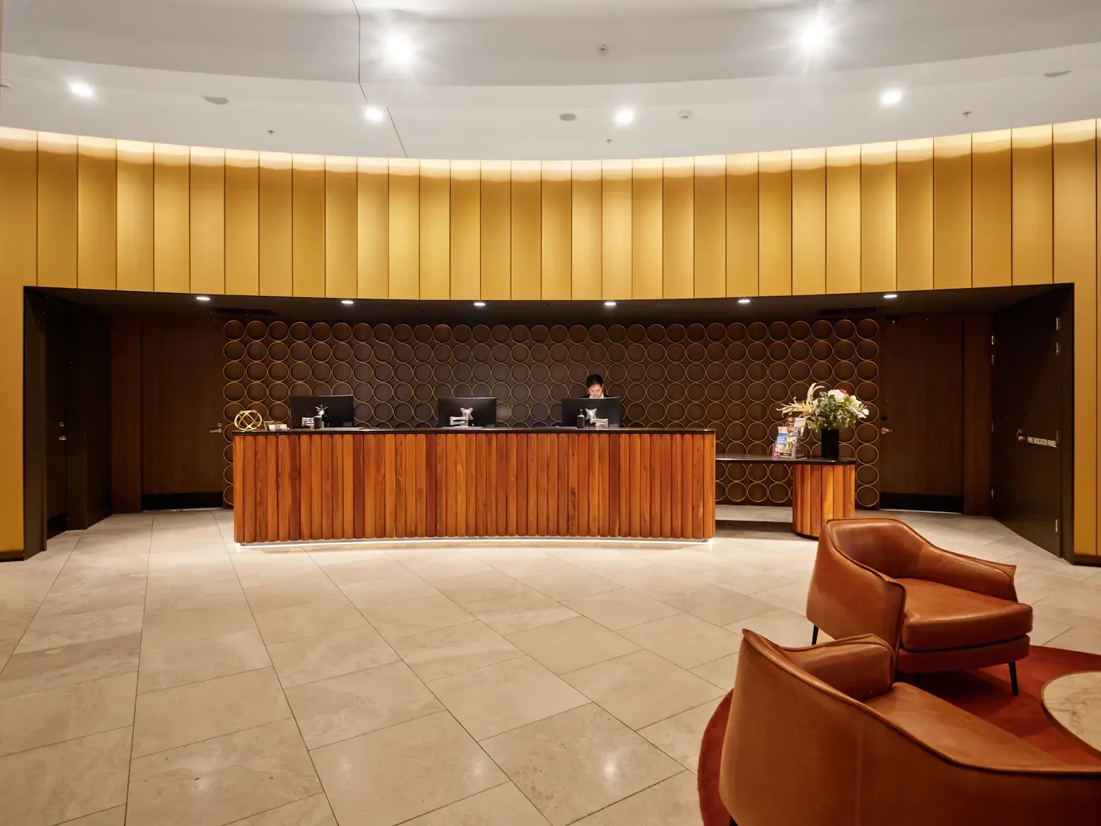 A hotel reception desk with staff behind it