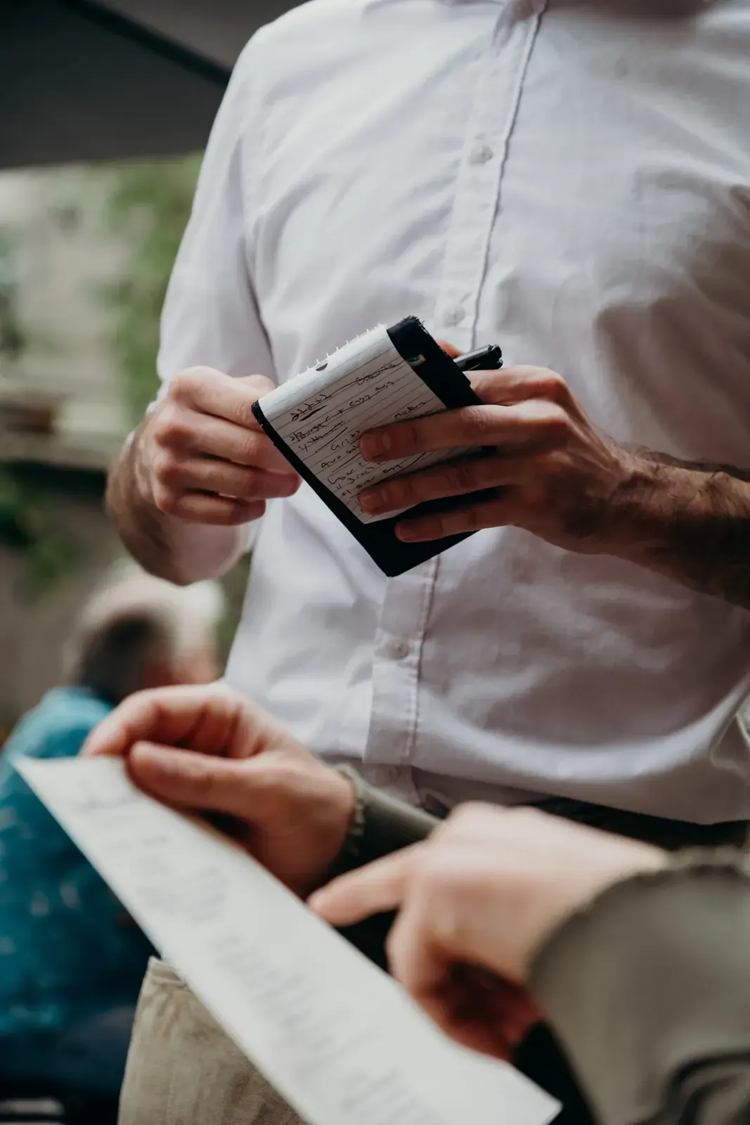 A server writes an order on a notepad
